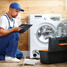 Technician writing a repair estimate on a tablet next to a front-load washer